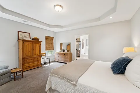 a bedroom with a bed and a dresser