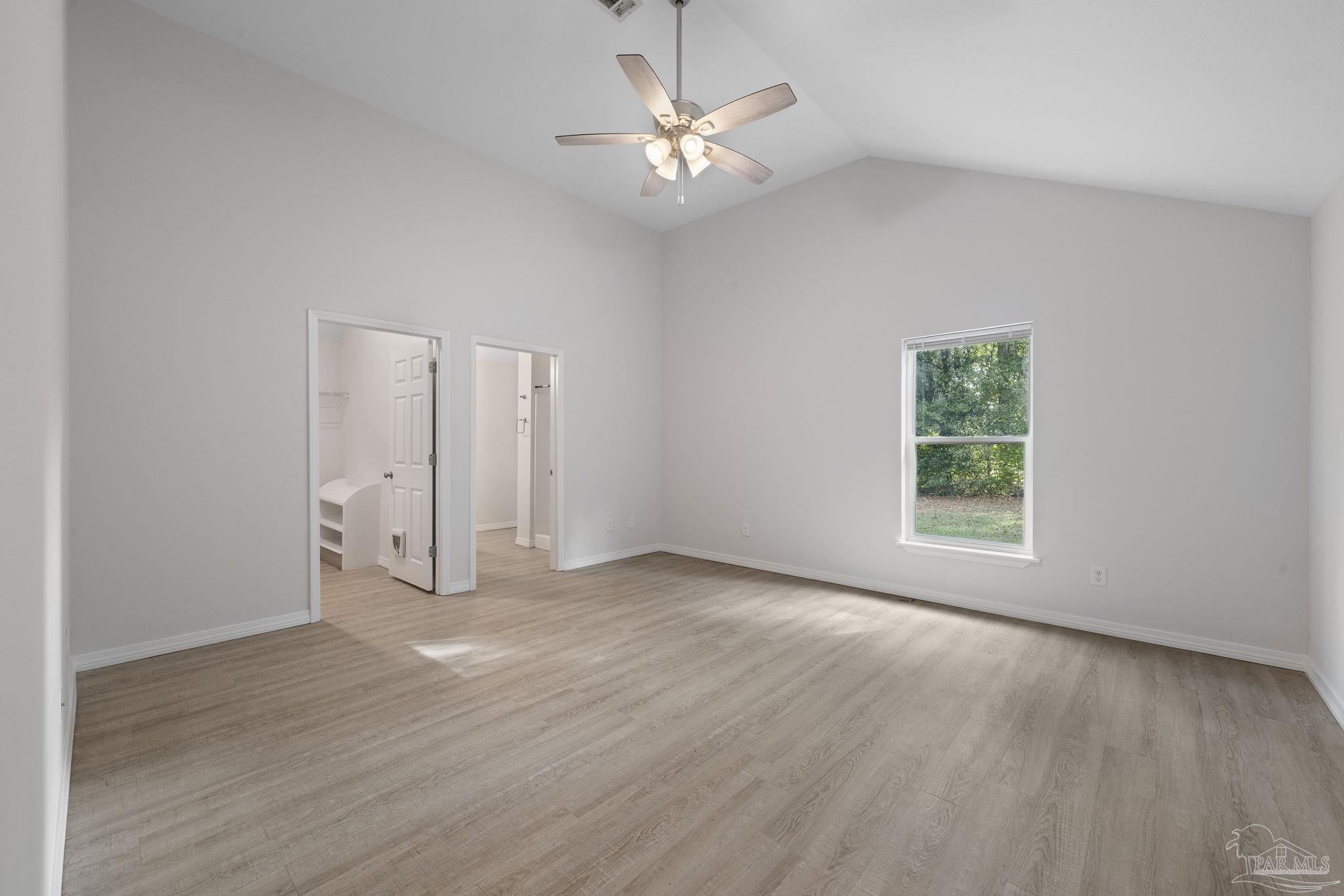 1039 Isabella Road Cantonment, FL 32533 - Photo 13 of 37 wooden floor in an empty room with a window