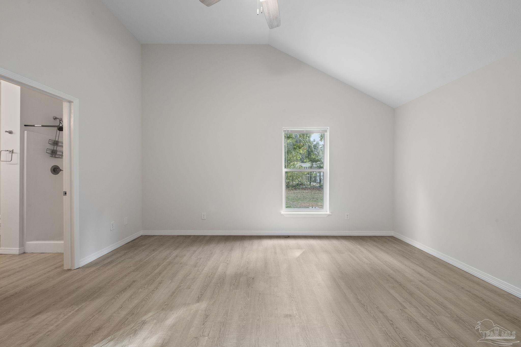 1039 Isabella Road Cantonment, FL 32533 - Photo 15 of 37 an empty room with wooden floor and window