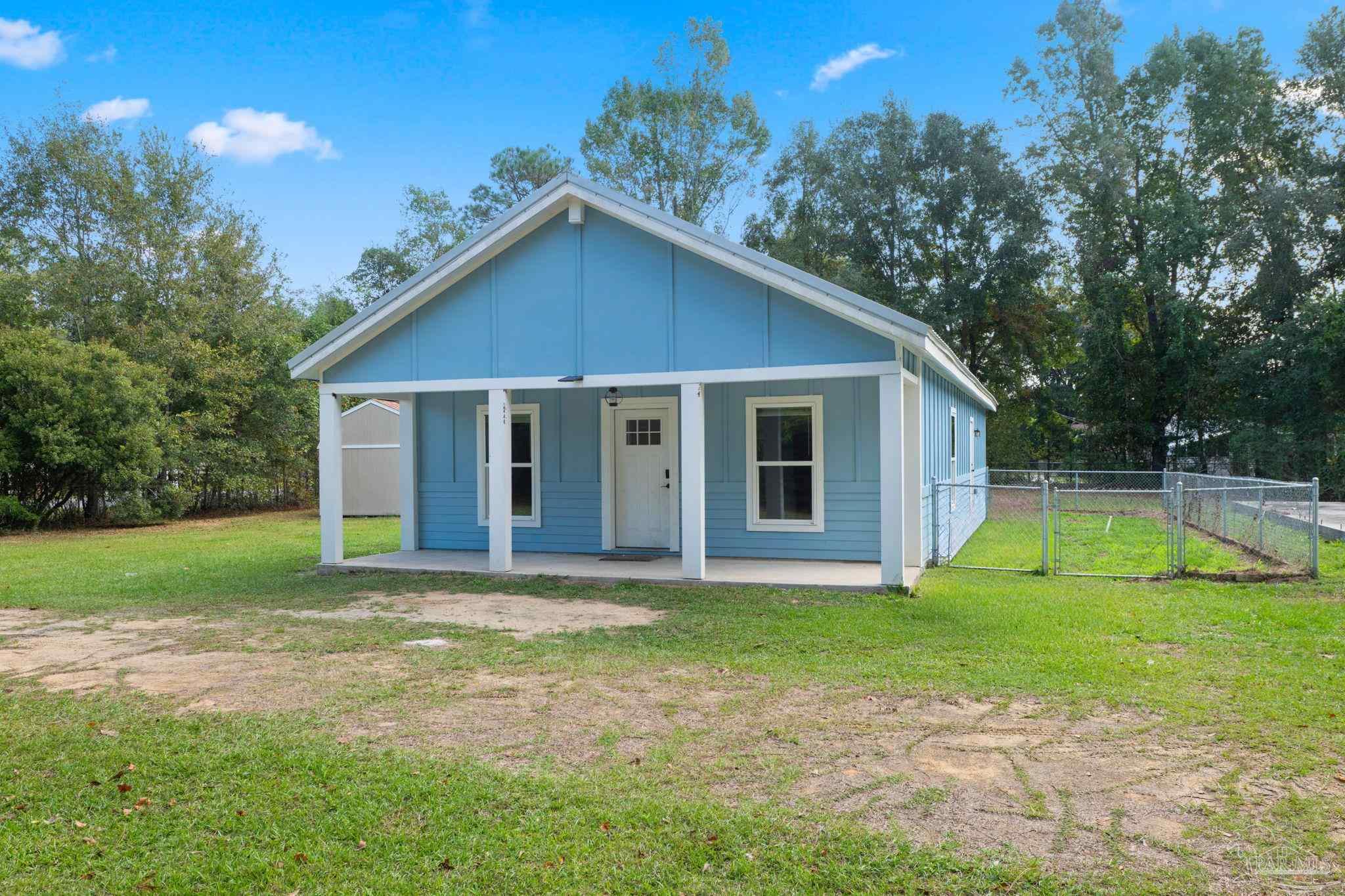 1039 Isabella Road Cantonment, FL 32533 - Photo 2 of 37 a view of a house with a yard
