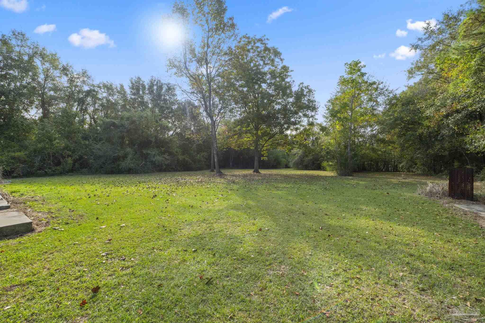 1039 Isabella Road Cantonment, FL 32533 - Photo 33 of 37 a view of a yard with a tree