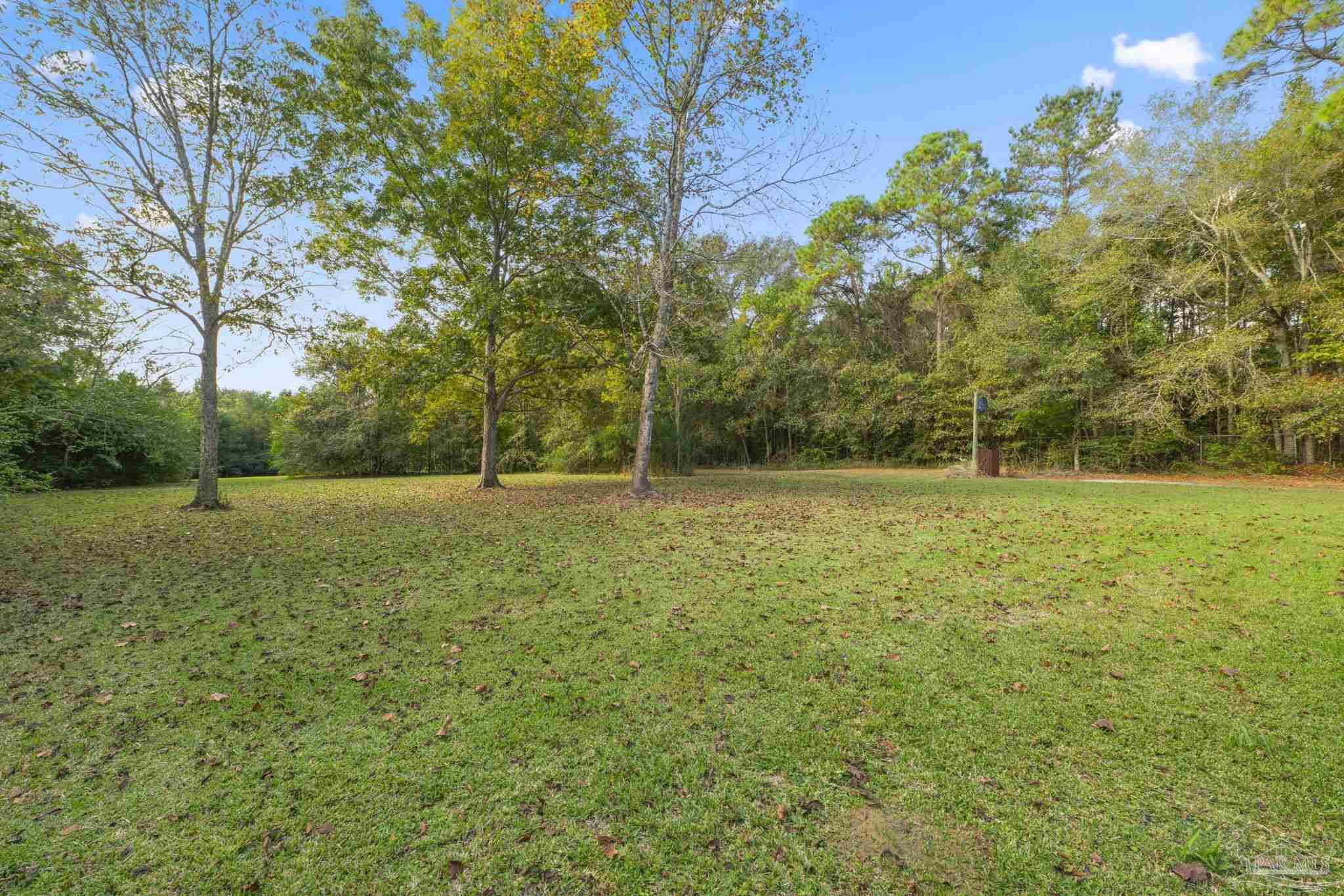 1039 Isabella Road Cantonment, FL 32533 - Photo 34 of 37 a view of outdoor space with deck and yard