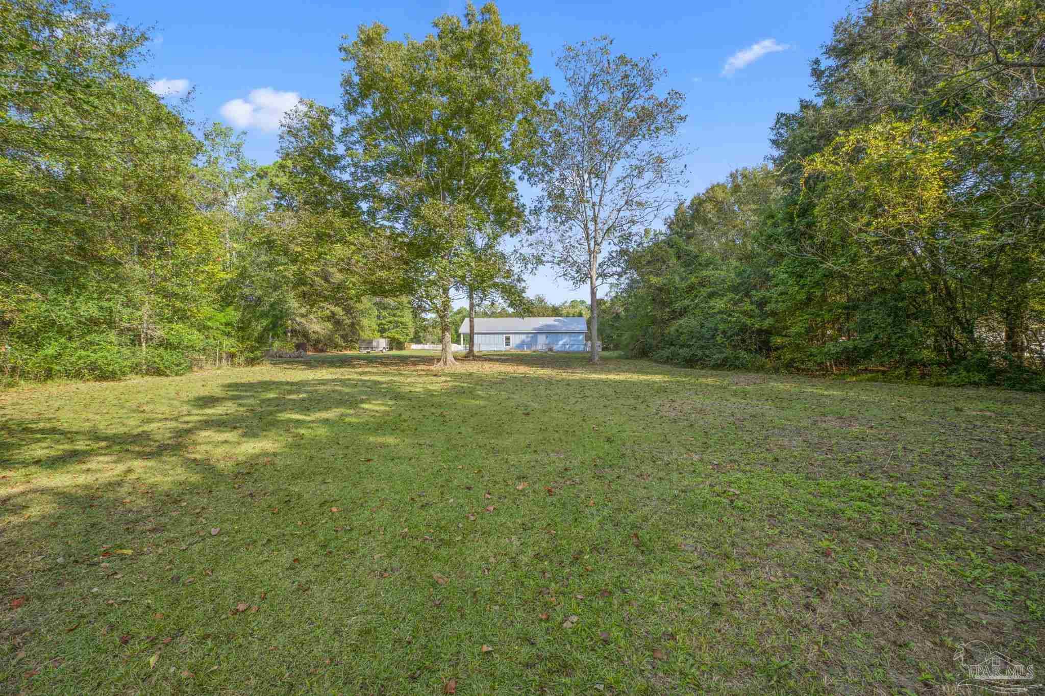1039 Isabella Road Cantonment, FL 32533 - Photo 36 of 37 a view of outdoor space with trees all around