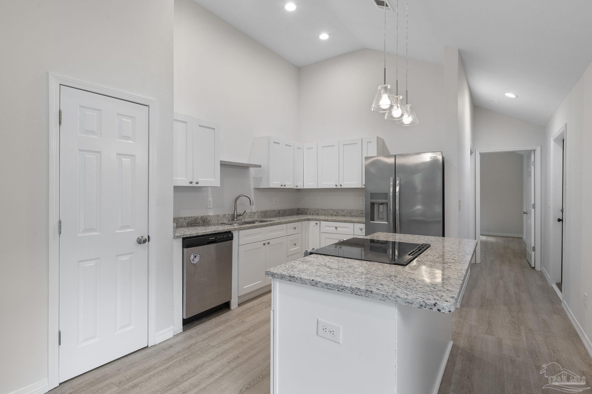 1039 Isabella Road Cantonment, FL 32533 - Photo 8 of 37 a kitchen with stainless steel appliances granite countertop a sink and refrigerator