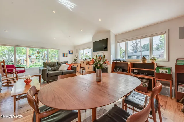 a living room with fireplace furniture and a wooden floor
