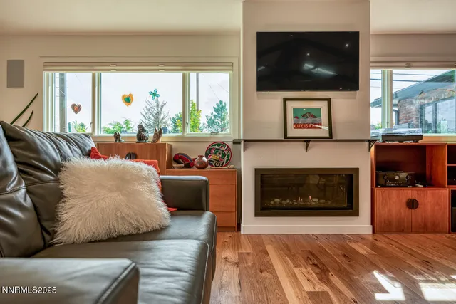 a living room with furniture and large windows
