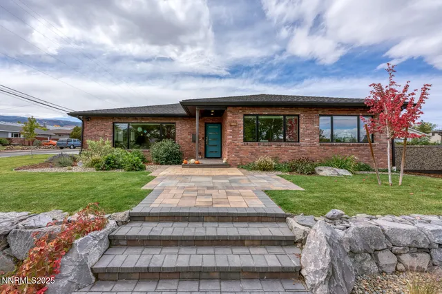 a front view of a house with garden