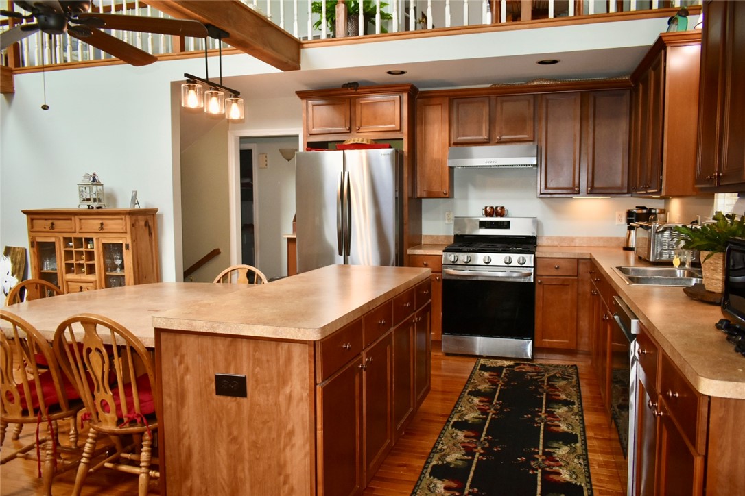 608 McKinney Way Westminster, SC 29693 - Photo 4 of 34 A well-appointed kitchen features rich wood cabinetry, stainless steel appliances, and an inviting island with seating.