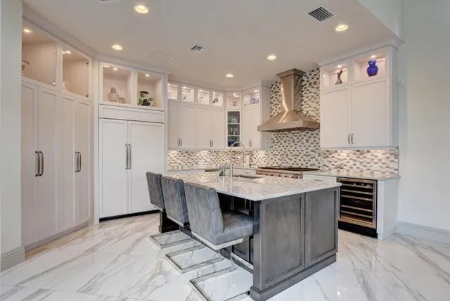 a kitchen with kitchen island a sink stainless steel appliances and cabinets