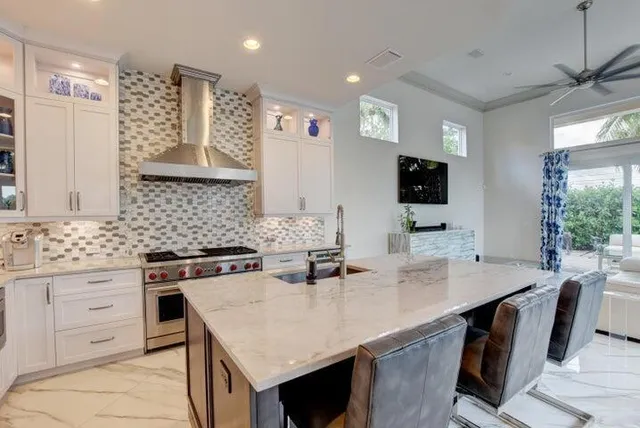 a kitchen with a stove a sink and a refrigerator