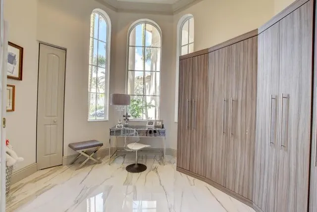 a view of a dining room with furniture and chandelier fan
