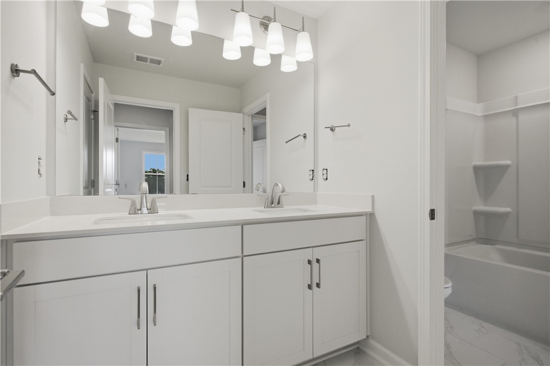 552 Hydrangea Street, Unit LOT 66 Seneca, SC 29678 - Photo 22 of 31 Twin vanities offer ample counter space in this well-appointed bathroom.