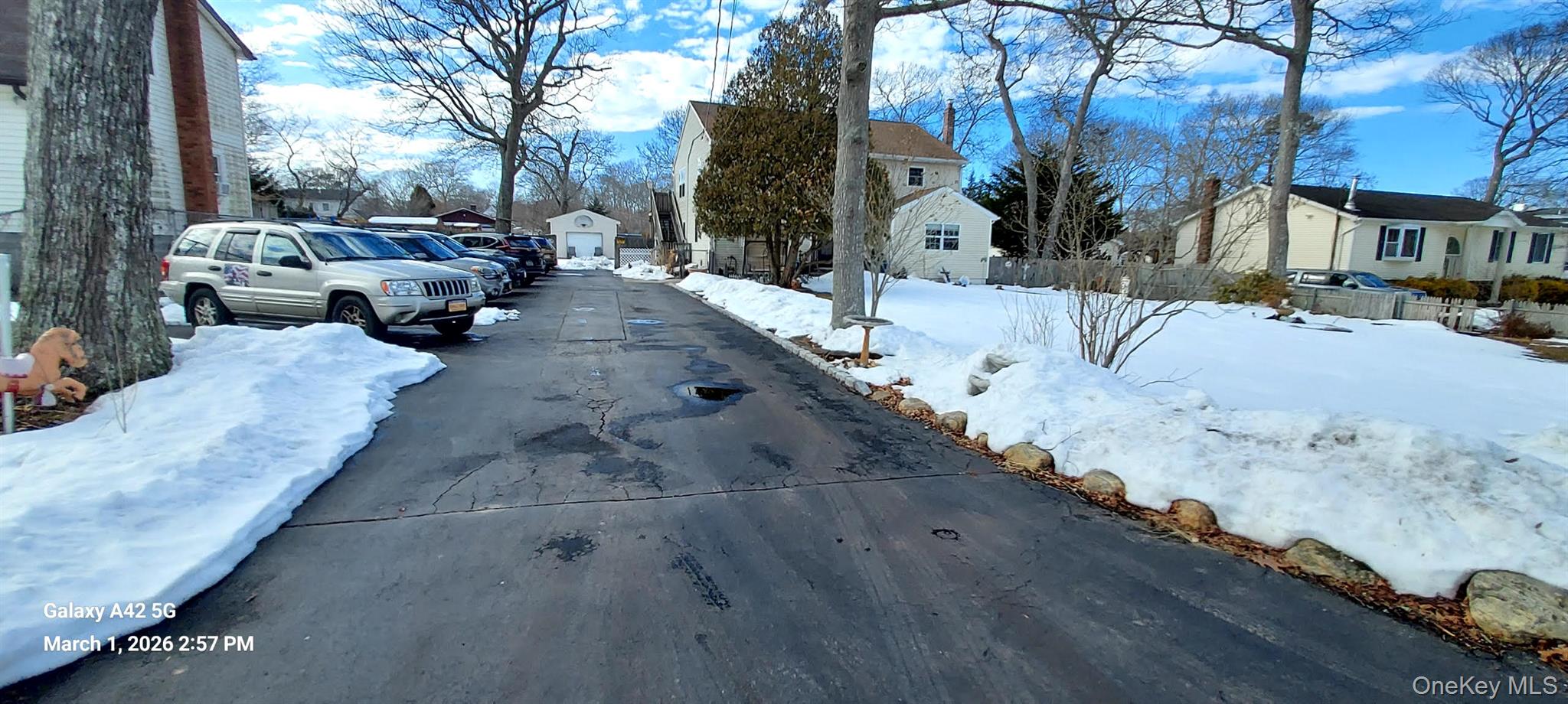 120 Stackyard Drive Mastic Beach, NY 11951 - Photo 2 of 17 a view of a yard with snow on the road