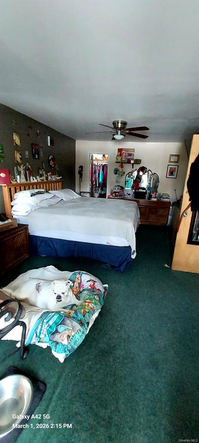 120 Stackyard Drive Mastic Beach, NY 11951 - Photo 6 of 17 a living room with furniture and a table