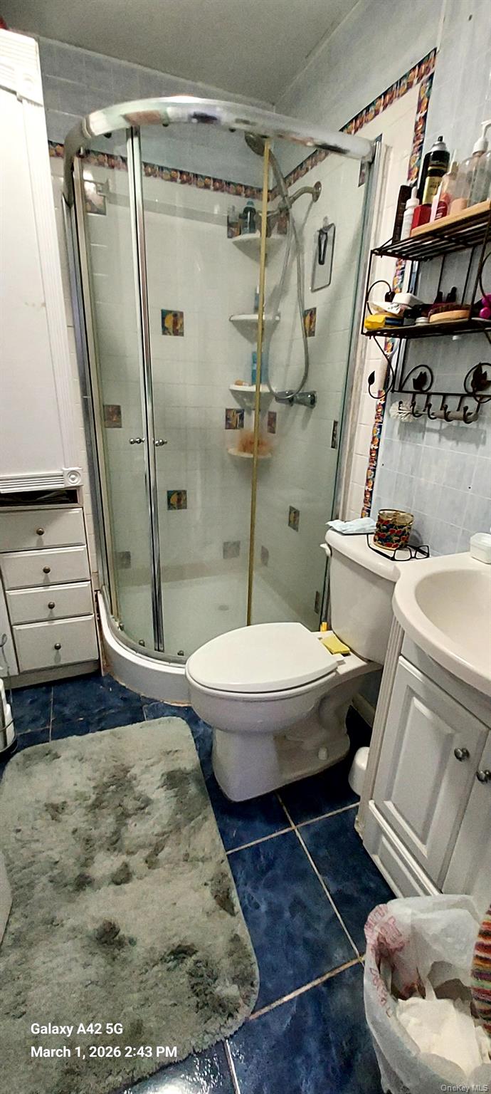 120 Stackyard Drive Mastic Beach, NY 11951 - Photo 8 of 17 a bathroom with a sink and a mirror