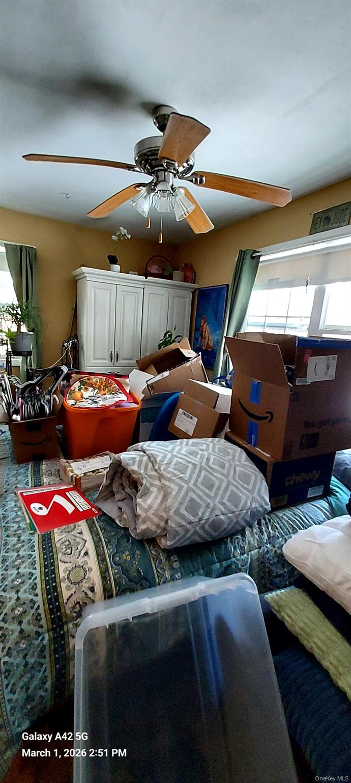 120 Stackyard Drive Mastic Beach, NY 11951 - Photo 10 of 17 a bedroom with furniture and a ceiling fan