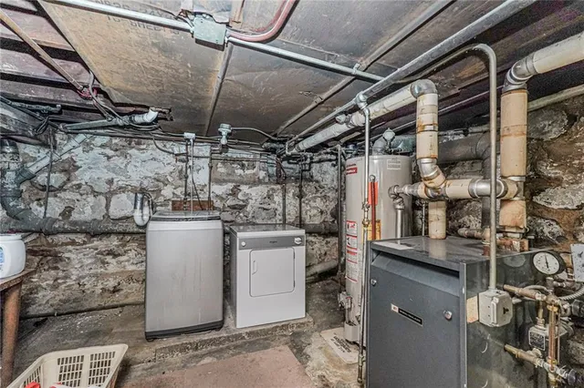 a kitchen with granite countertop a stove a sink and a refrigerator