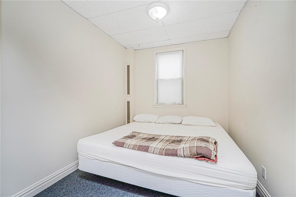 329 80th Street Brooklyn, NY 11209 - Photo 16 of 34 a bedroom with a bed and a window