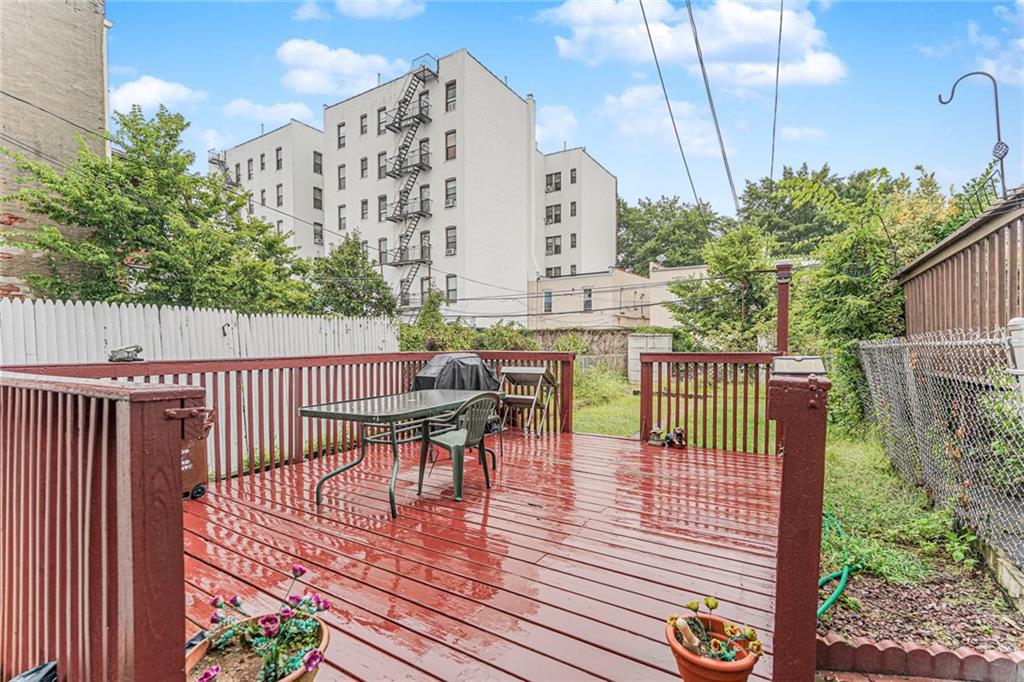 329 80th Street Brooklyn, NY 11209 - Photo 2 of 34 a balcony with wooden floor table and chairs