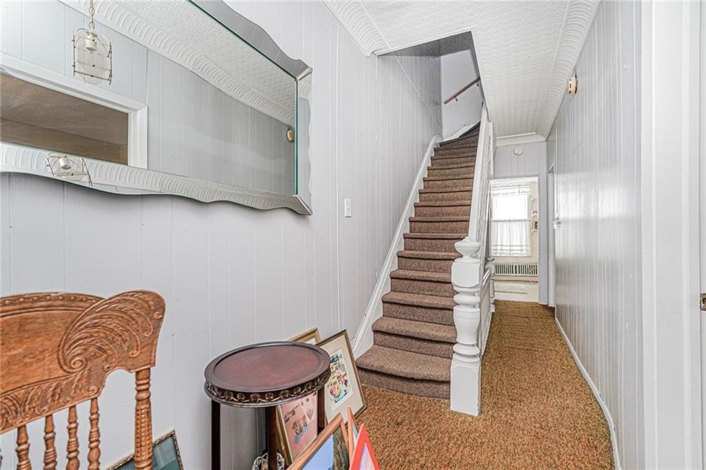 329 80th Street Brooklyn, NY 11209 - Photo 24 of 34 a living room with furniture and a fireplace