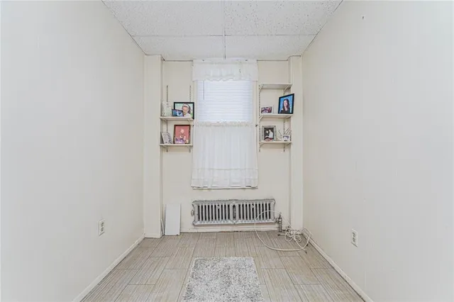 a room with a bed and a dresser