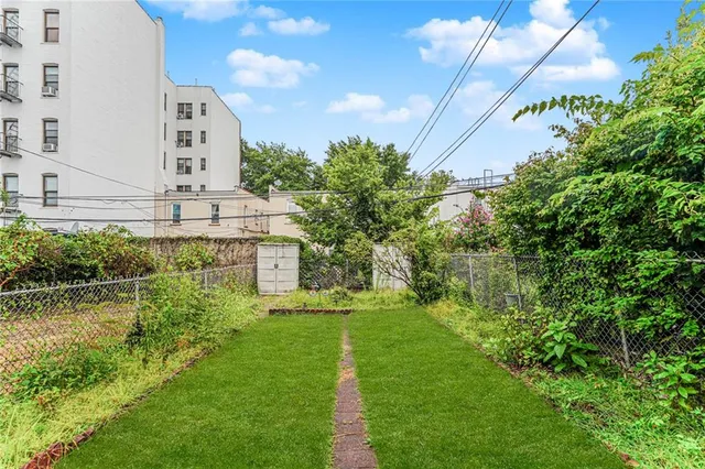 a view of a house with a backyard and sitting area