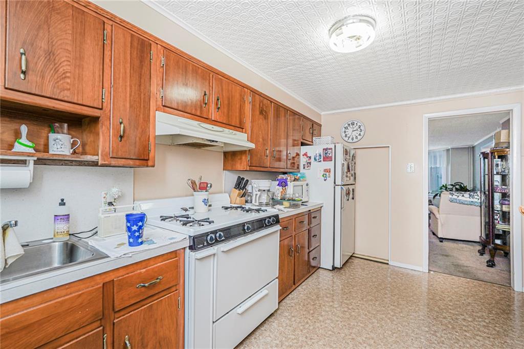 329 80th Street Brooklyn, NY 11209 - Photo 8 of 34 a kitchen with stainless steel appliances granite countertop a sink stove and cabinets