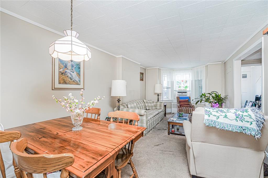 329 80th Street Brooklyn, NY 11209 - Photo 9 of 34 a living room with fireplace furniture and a chandelier