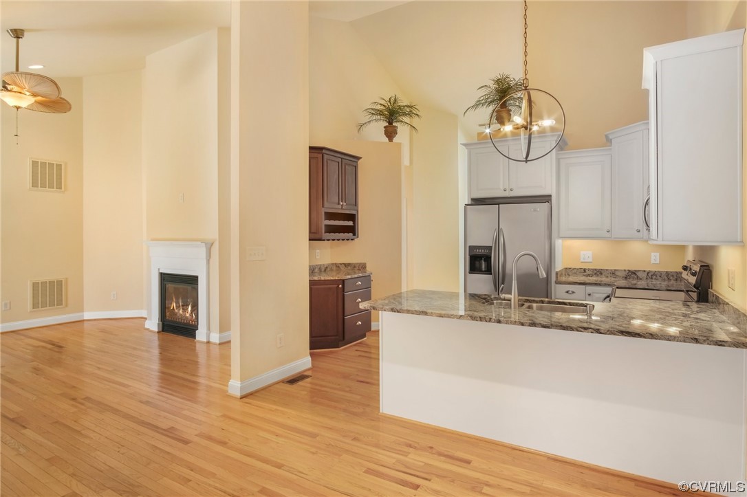 740 Marsh Pungo Road, Unit 8 Locust Hill, VA 23092 - Photo 11 of 50 a kitchen with stainless steel appliances granite countertop a sink a refrigerator and a stove top oven