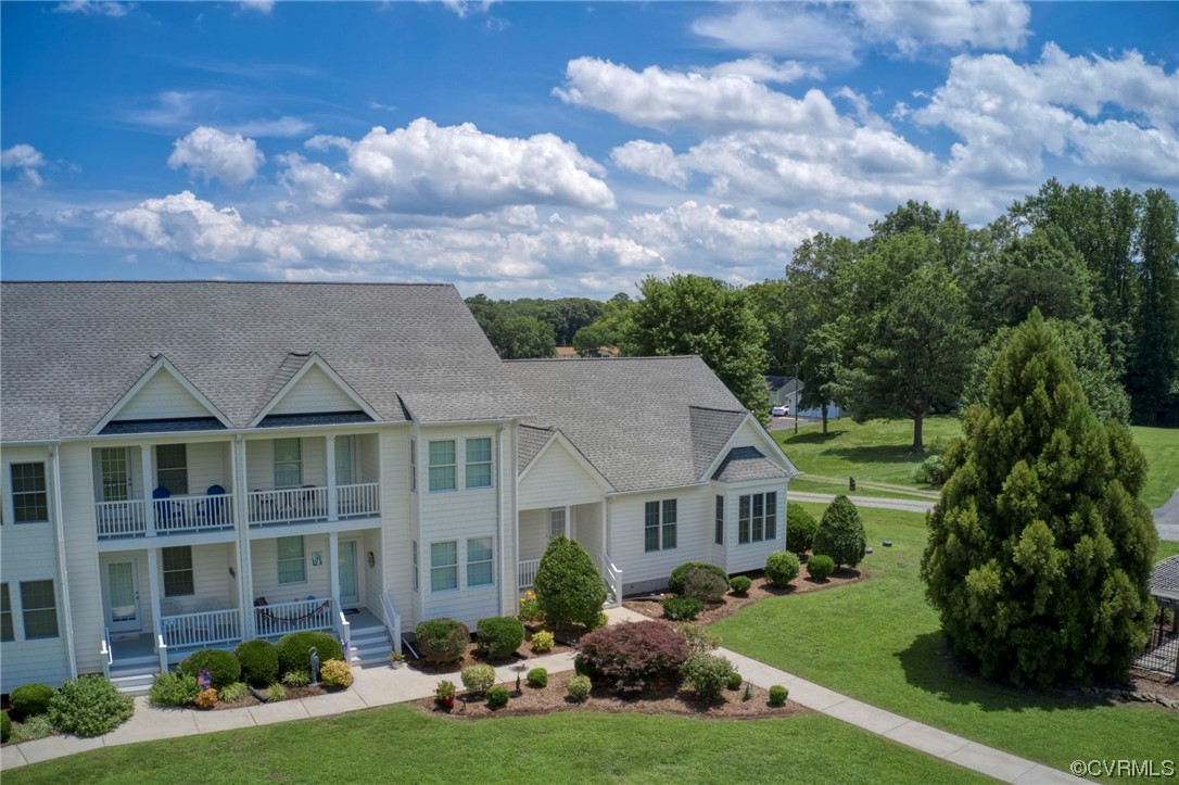 740 Marsh Pungo Road, Unit 8 Locust Hill, VA 23092 - Photo 3 of 50 a front view of a house with a garden