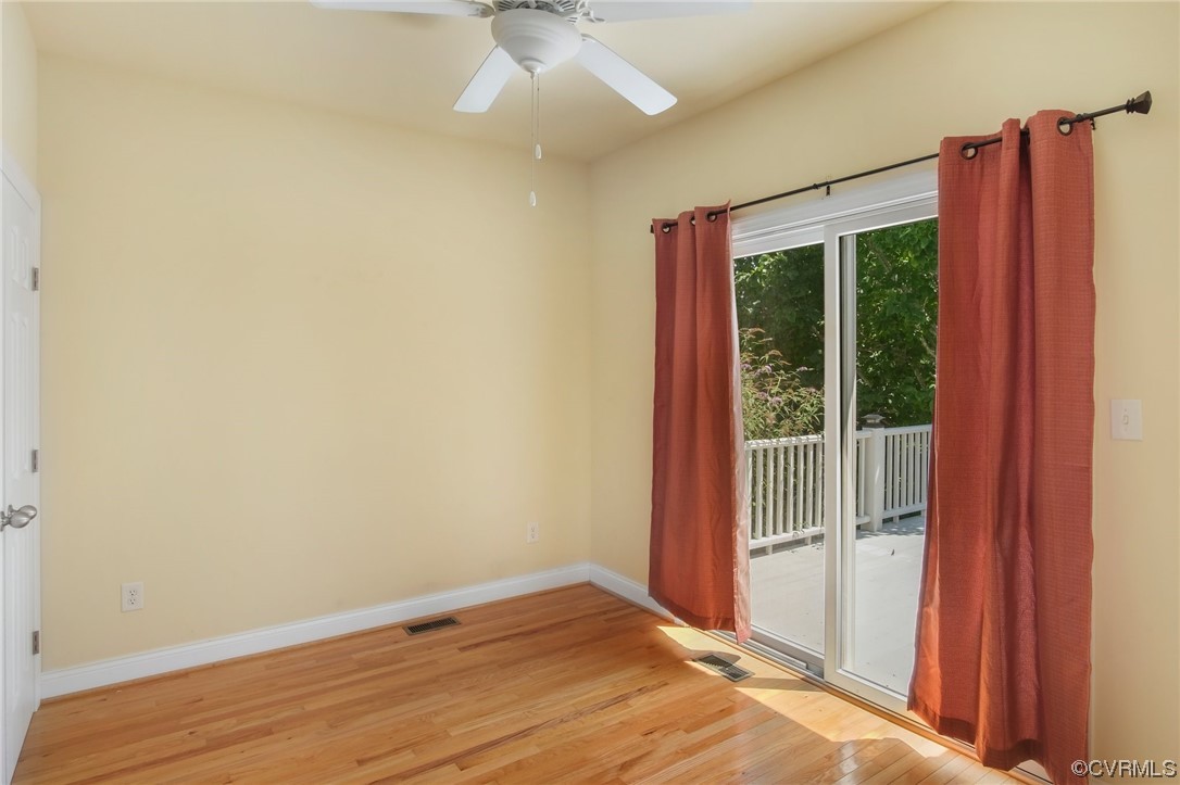 740 Marsh Pungo Road, Unit 8 Locust Hill, VA 23092 - Photo 33 of 50 an empty room with wooden floor fan and windows