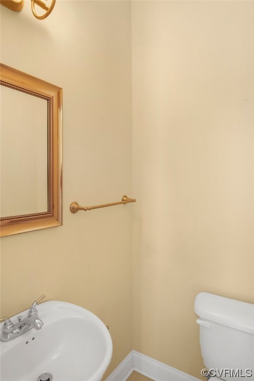 740 Marsh Pungo Road, Unit 8 Locust Hill, VA 23092 - Photo 34 of 50 a white toilet sitting next to a bathroom sink