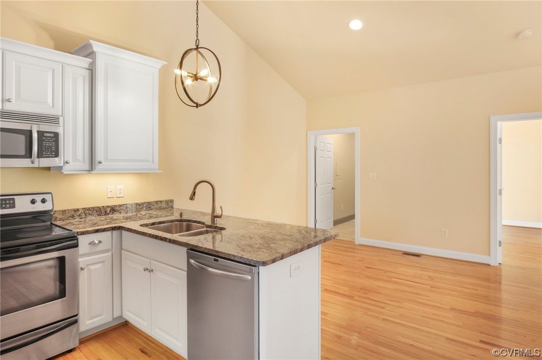 740 Marsh Pungo Road, Unit 8 Locust Hill, VA 23092 - Photo 9 of 50 a kitchen with stainless steel appliances granite countertop a sink dishwasher and a stove with wooden floor