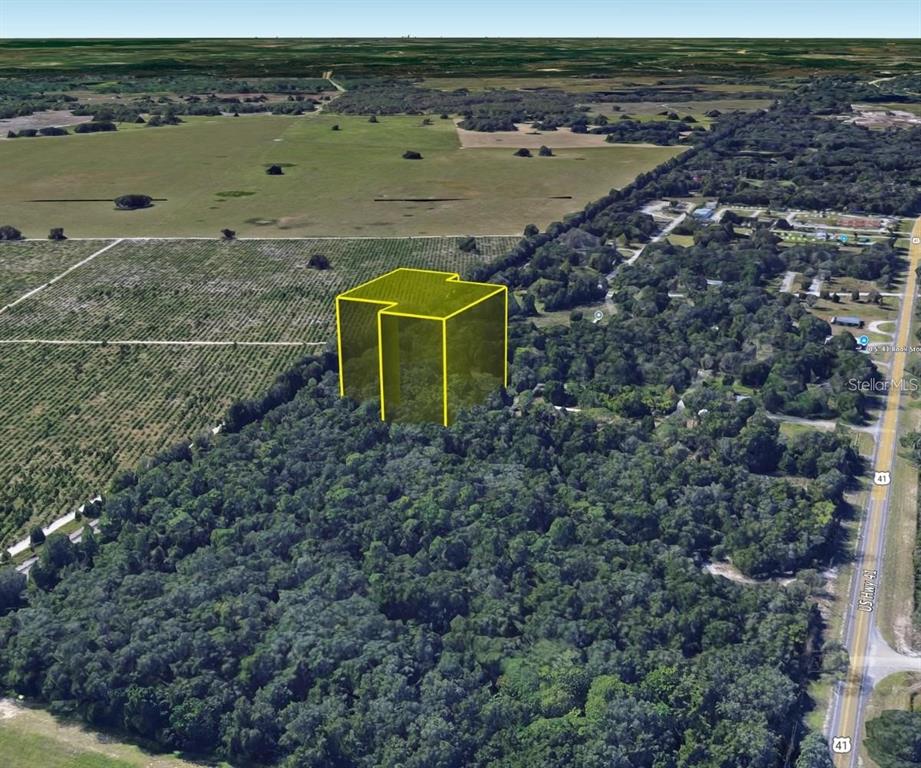 17314 Putter Lane Spring Hill, FL 34610 - Photo 8 of 9 an aerial view of a house with a lake