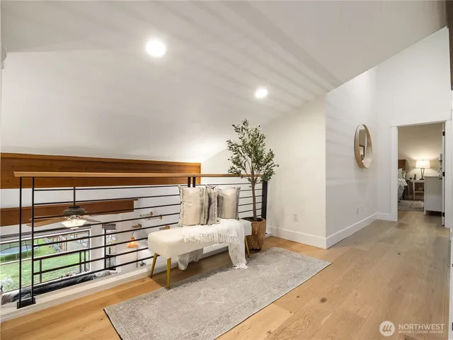 a bedroom with a bed a chandelier and a dresser