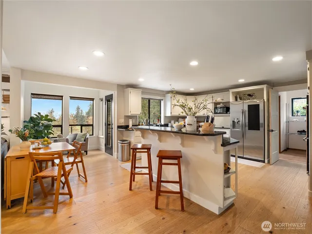 a living room with furniture and kitchen view