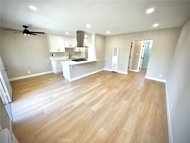 a view of kitchen with granite countertop cabinets and refrigerator