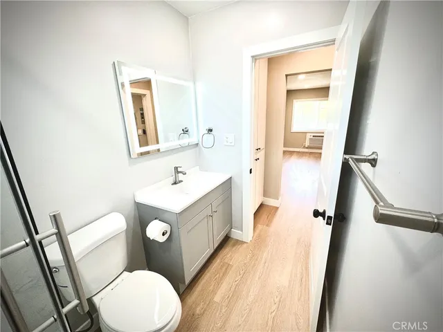 a white toilet sitting next to a bathroom sink