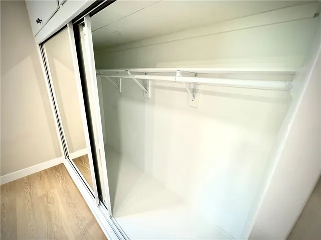 a view of closet with wooden floor