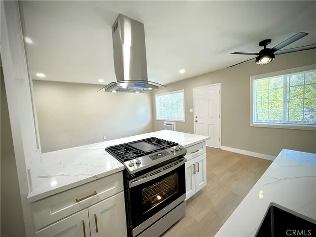a kitchen with stainless steel appliances granite countertop a stove and a sink