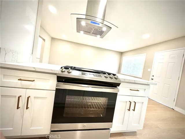 a stove top oven sitting inside of a kitchen