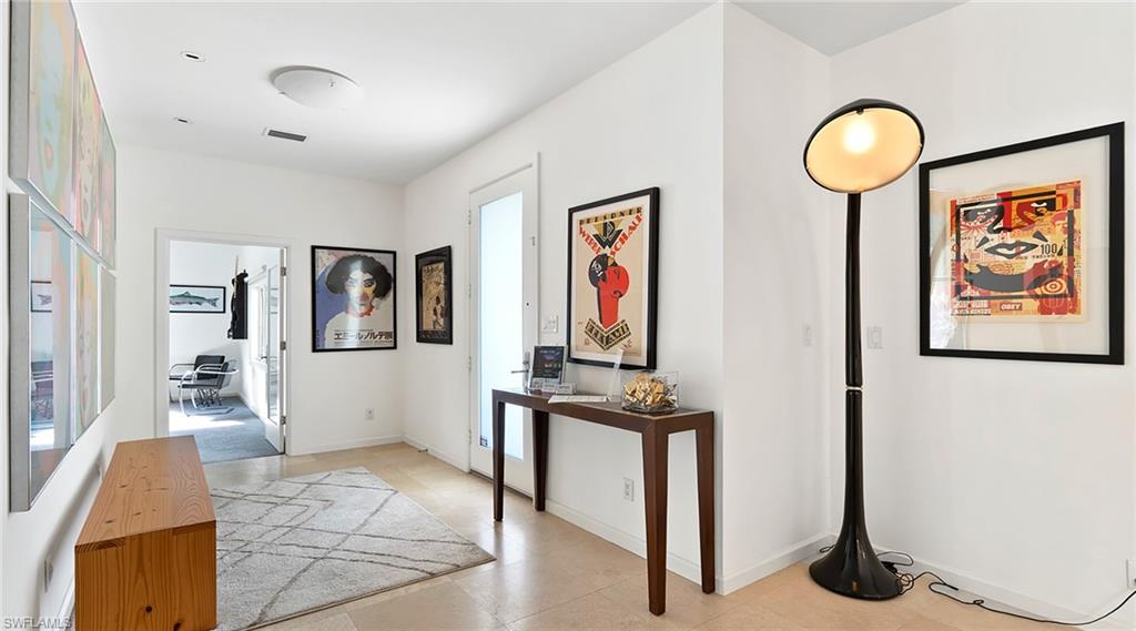 586 Yucca Road Naples, FL 34102 - Photo 4 of 26 Hallway featuring an office area and baseboards