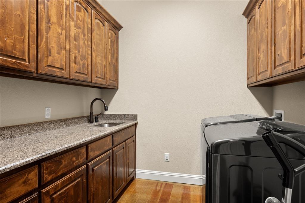 104 Rattling Antler Court Azle, TX 76020 - Photo 16 of 38 Laundry room with storage, hanging rack, folding counter.