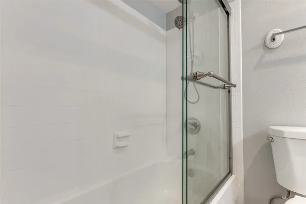 a bathroom with a glass shower door