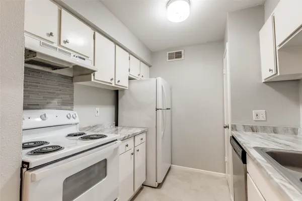 a kitchen with stainless steel appliances a stove a sink and a refrigerator