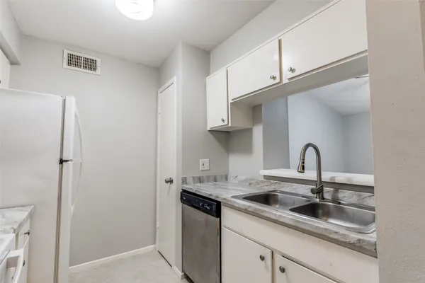 a kitchen with stainless steel appliances granite countertop a sink and cabinets