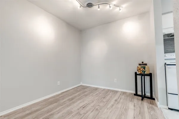 a view of a room with wooden floor and a window