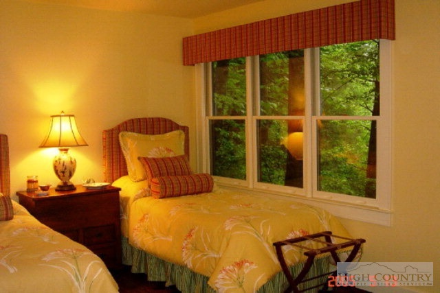 775 Meadow Road Ferguson, NC 28624 - Photo 18 of 20 a bedroom with a bed and a window