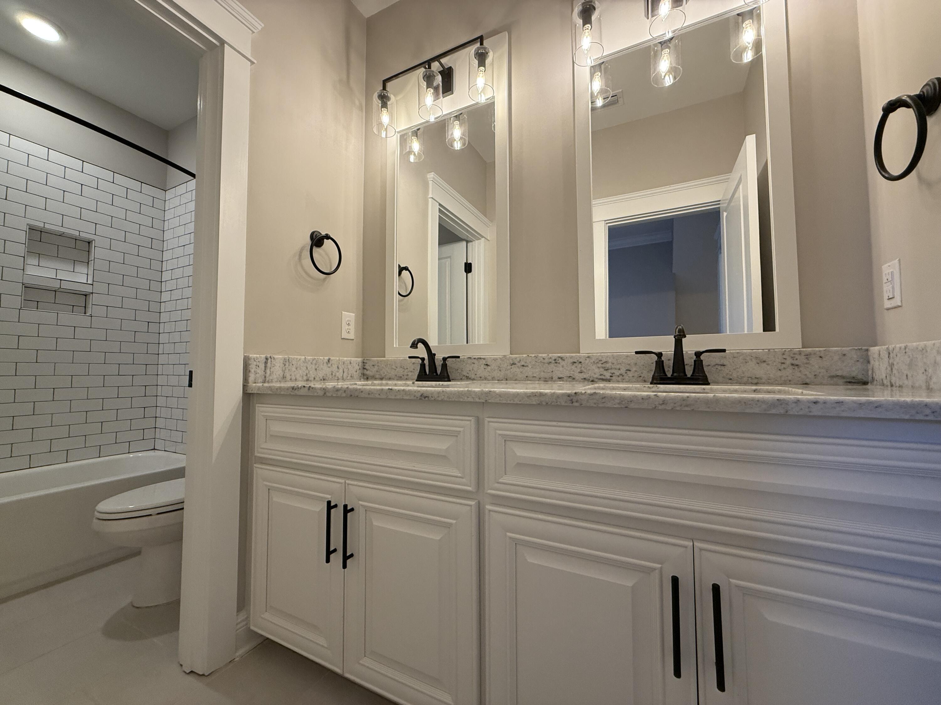 79 Mill Pond Cove Freeport, FL 32439 - Photo 39 of 63 a bathroom with a sink and mirror with toilet