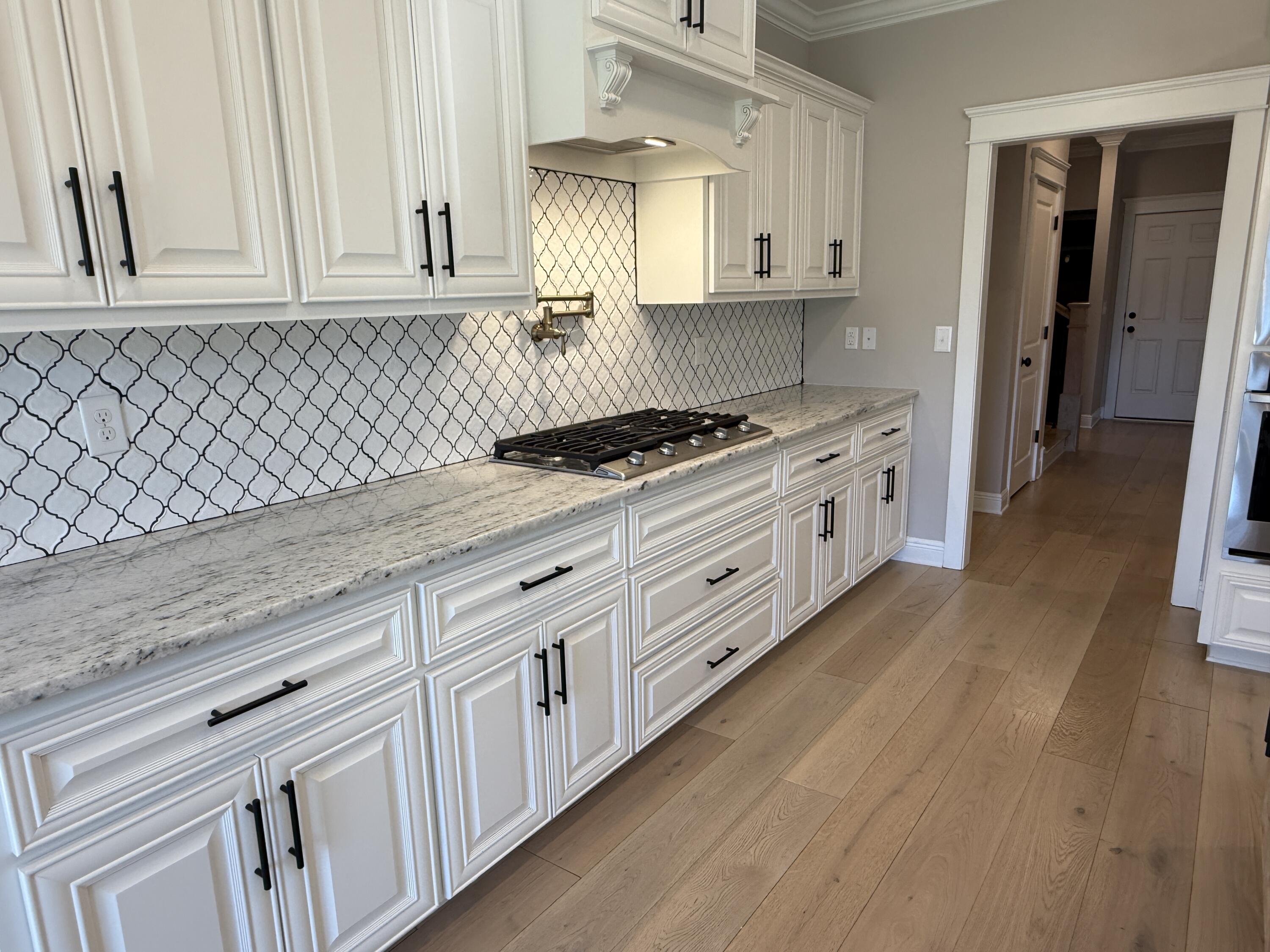 79 Mill Pond Cove Freeport, FL 32439 - Photo 49 of 63 a kitchen with granite countertop white cabinets and white appliances